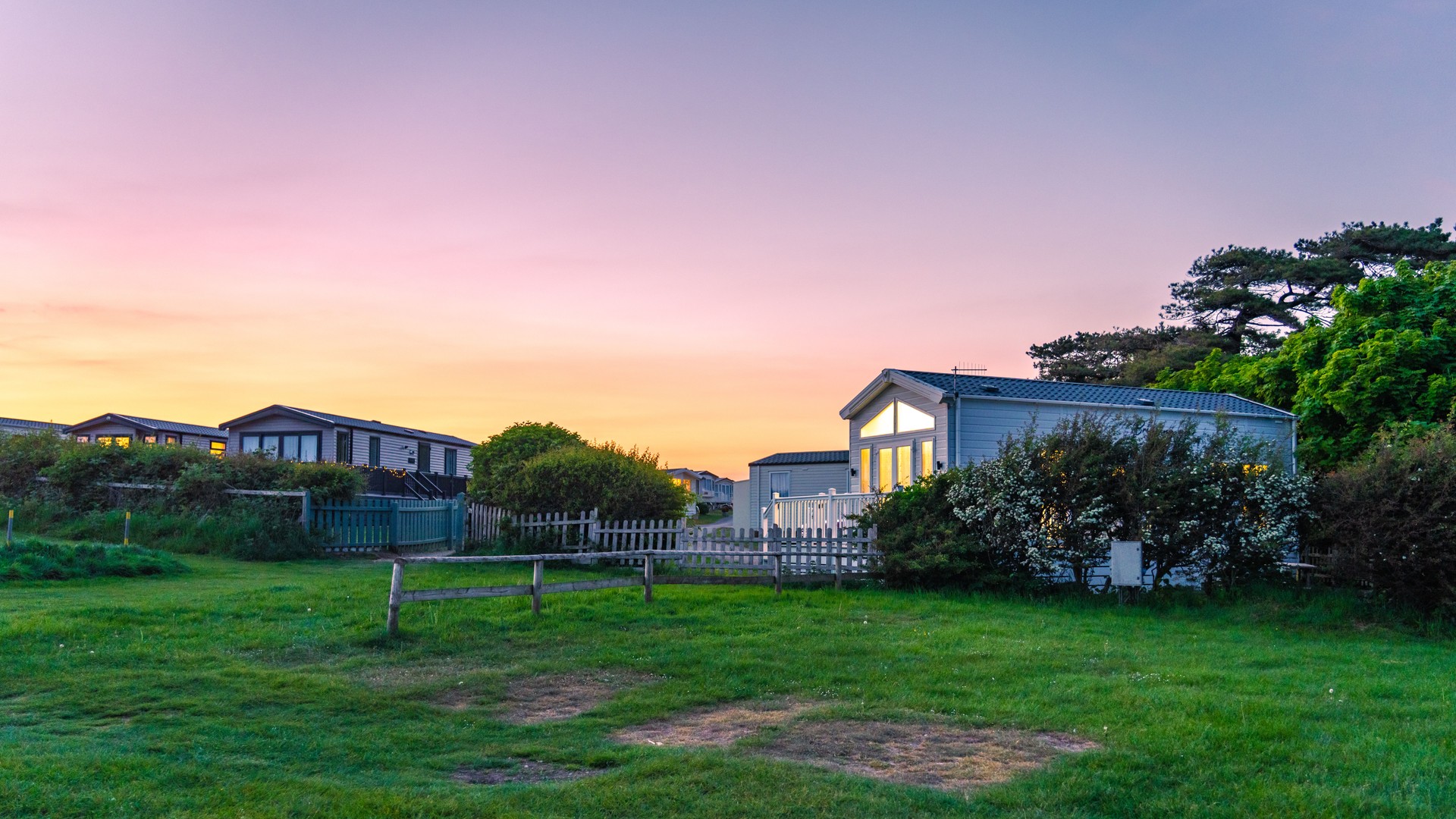 Sunset over caravan park in dorset, england, creating a peaceful vacation atmosphere