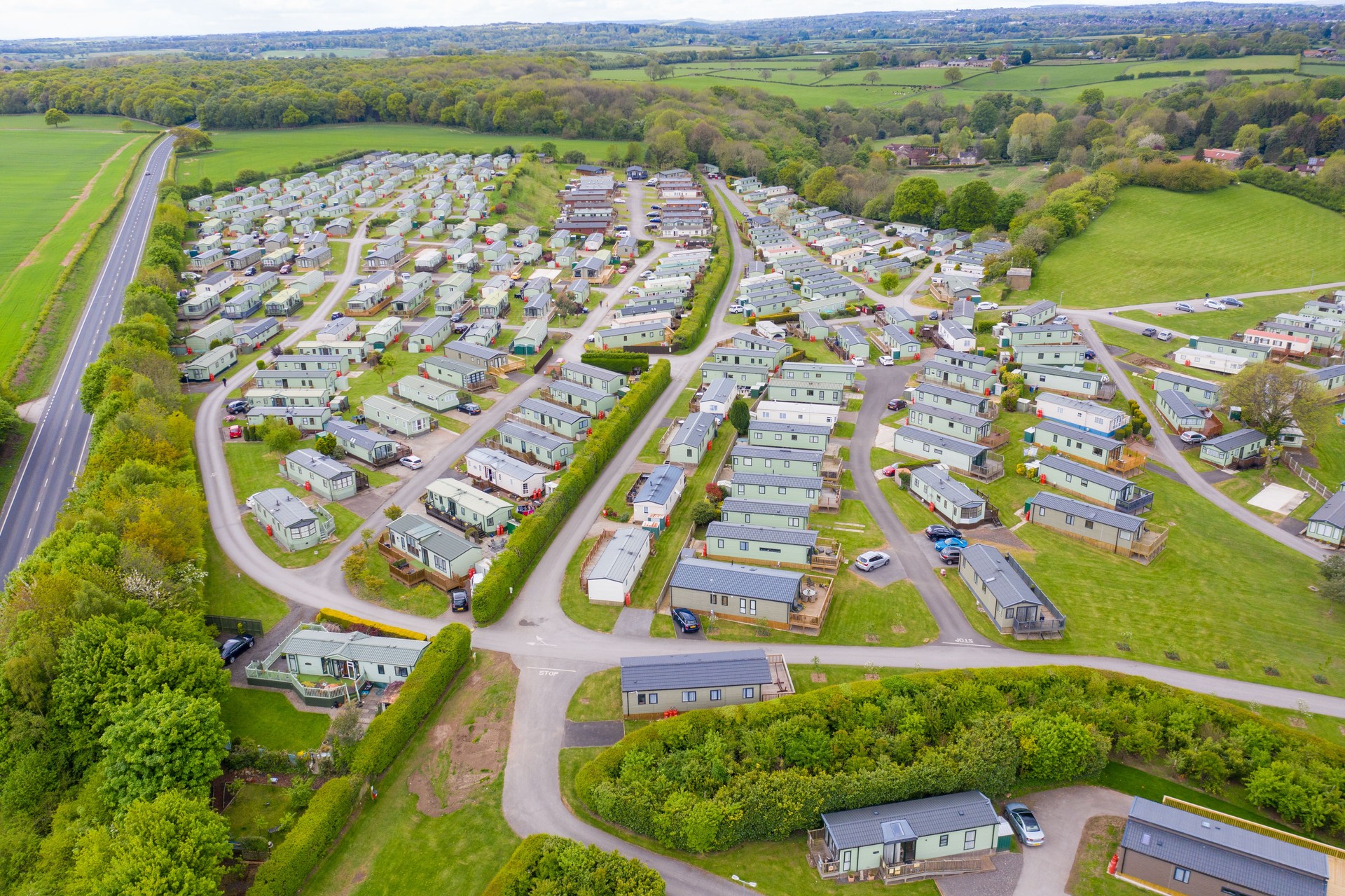 Aerial photo of the Lido Leisure Park caravan park located in in the village of Knaresborough in North Yorkshire in the UK showing rows of static caravans and motorhomes